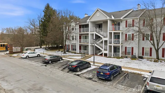 a car parked in front of a white house