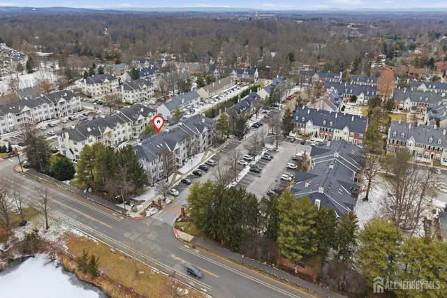an aerial view of residential houses with city view
