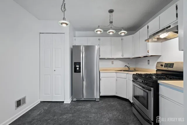 a kitchen with a sink stainless steel appliances and cabinets