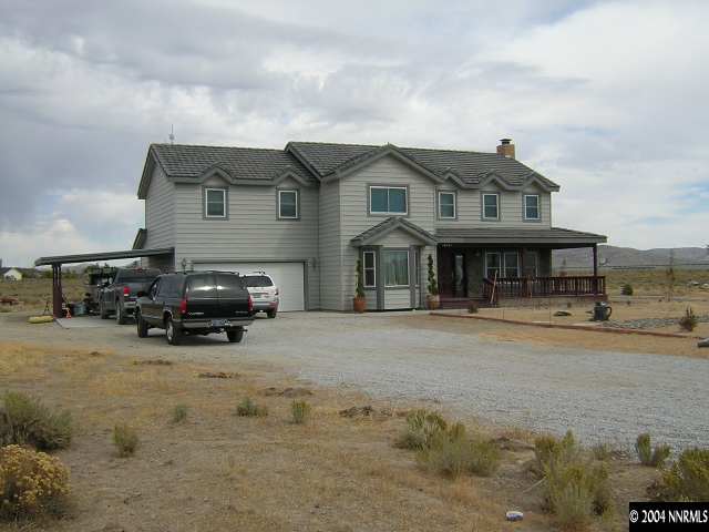10101 Osage Road Reno, NV 89508 - Photo 1 of 9 a view of a house with a large space and a car parked in front of it