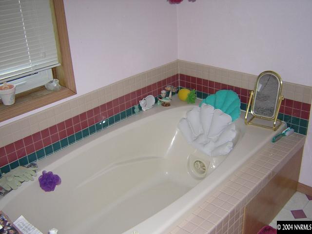 10101 Osage Road Reno, NV 89508 - Photo 8 of 9 a bathroom with a bathtub and a sink