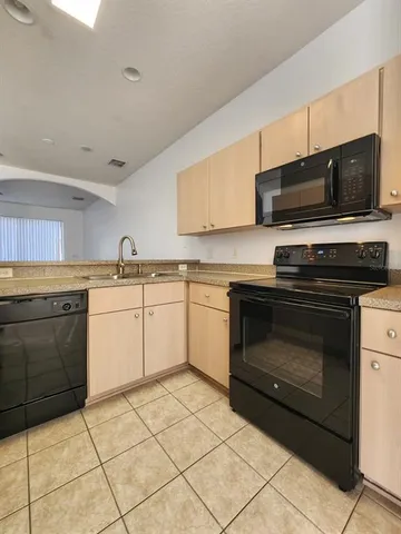 a kitchen with a stove top oven sink and cabinets