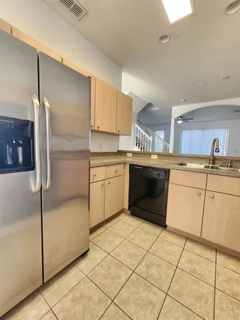 a kitchen with a stove sink and cabinets