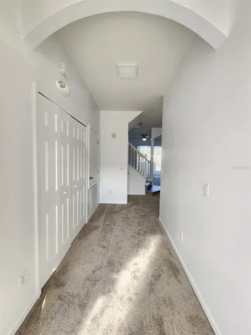 a view of a hallway view with staircase