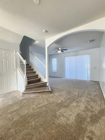 a view of an empty room with stairs