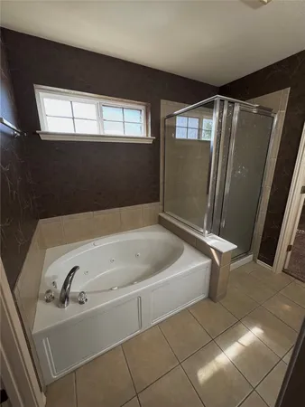 a bathroom with a bathtub and a window
