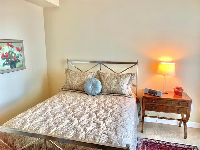 a bedroom with a bed and a chair