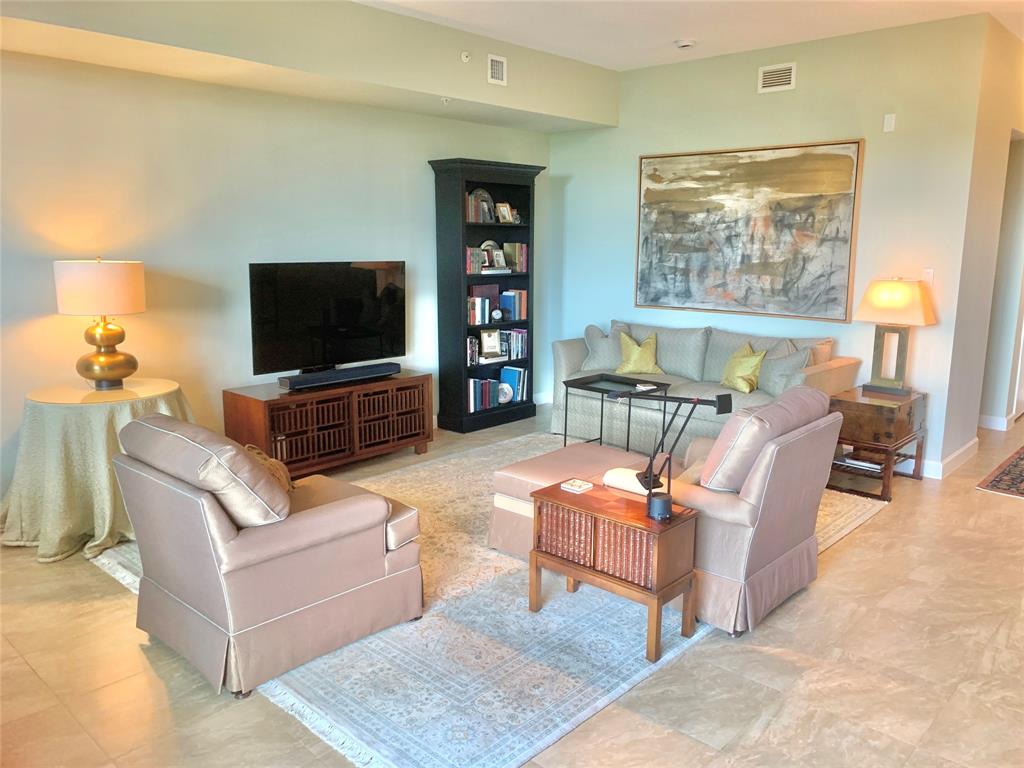 2301 Wilton Drive, Unit R409 Wilton Manors, FL 33305 - Photo 2 of 38 a living room with furniture and a flat screen tv
