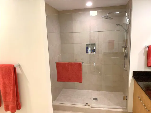 a bathroom with a shower and a bath tub