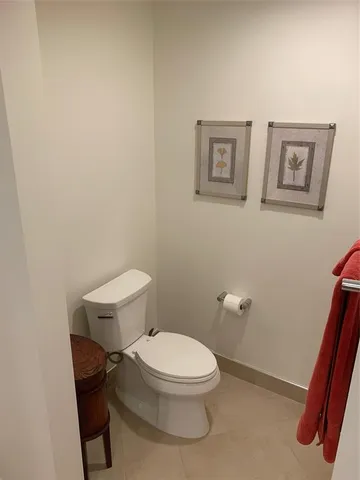 a white toilet sitting next to a small bathroom