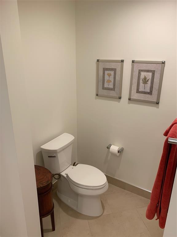 2301 Wilton Drive, Unit R409 Wilton Manors, FL 33305 - Photo 25 of 38 a white toilet sitting next to a small bathroom