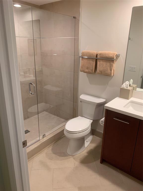 2301 Wilton Drive, Unit R409 Wilton Manors, FL 33305 - Photo 27 of 38 a bathroom with a toilet and a shower