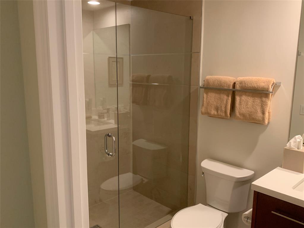 2301 Wilton Drive, Unit R409 Wilton Manors, FL 33305 - Photo 30 of 38 a white toilet sitting next to a bathroom sink