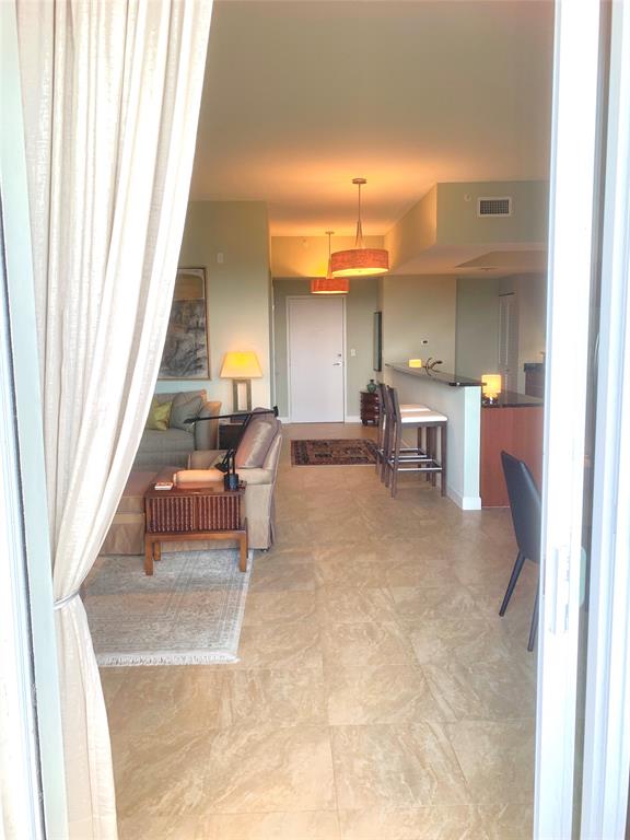 2301 Wilton Drive, Unit R409 Wilton Manors, FL 33305 - Photo 3 of 38 a living room with furniture and a fireplace