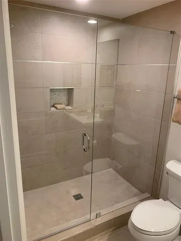 a bathroom with a shower and toilet