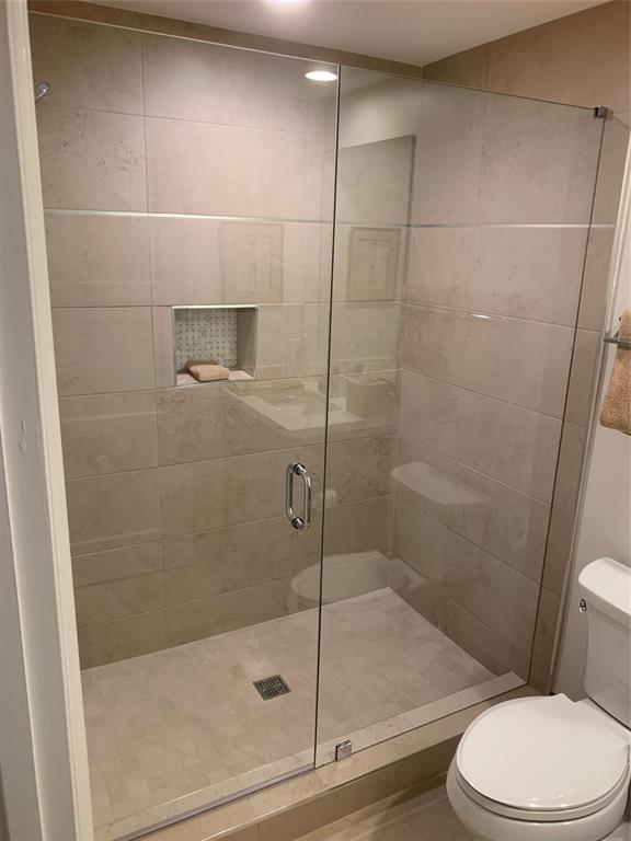 2301 Wilton Drive, Unit R409 Wilton Manors, FL 33305 - Photo 31 of 38 a bathroom with a shower and toilet