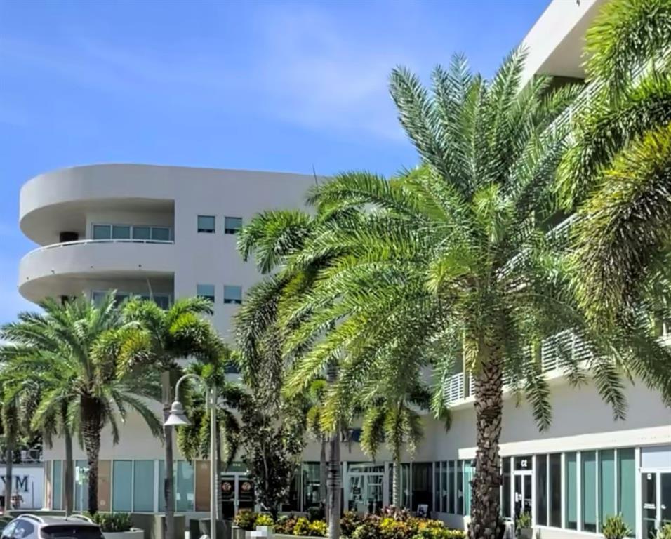2301 Wilton Drive, Unit R409 Wilton Manors, FL 33305 - Photo 36 of 38 a picture of a building with a tree in front