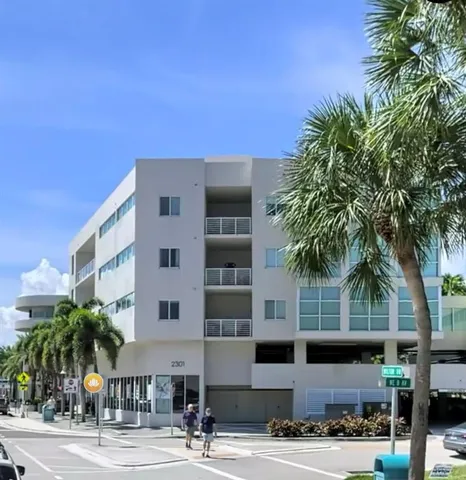a front view of a building with tree s