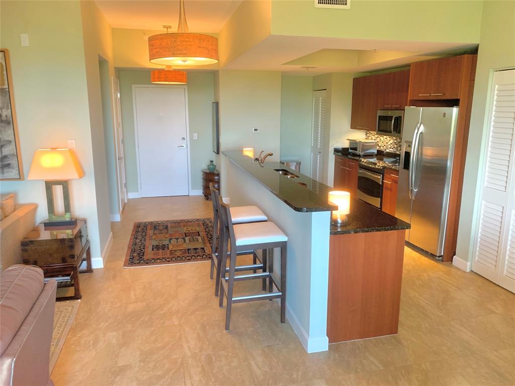 2301 Wilton Drive, Unit R409 Wilton Manors, FL 33305 - Photo 8 of 38 a kitchen with kitchen island counter top space