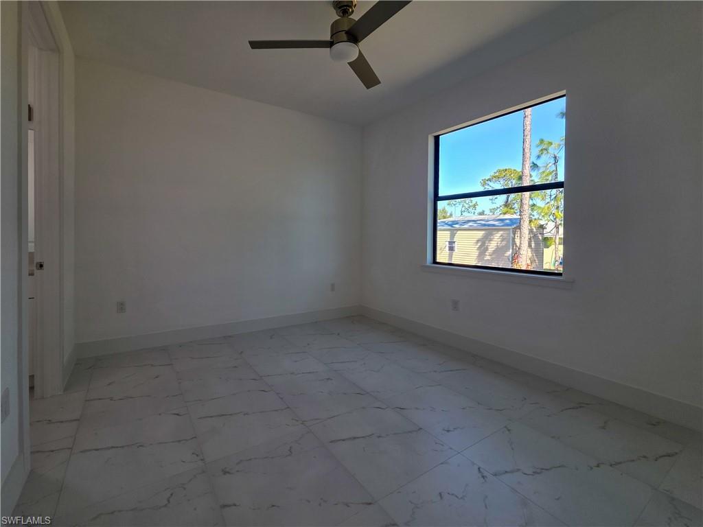 4814 30th Street Southwest Lehigh Acres, FL 33973 - Photo 6 of 11 an empty room with windows