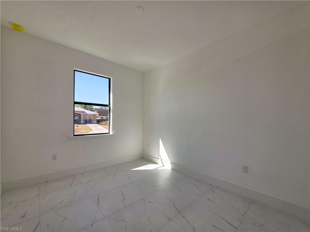 4814 30th Street Southwest Lehigh Acres, FL 33973 - Photo 8 of 11 a view of an empty room and window
