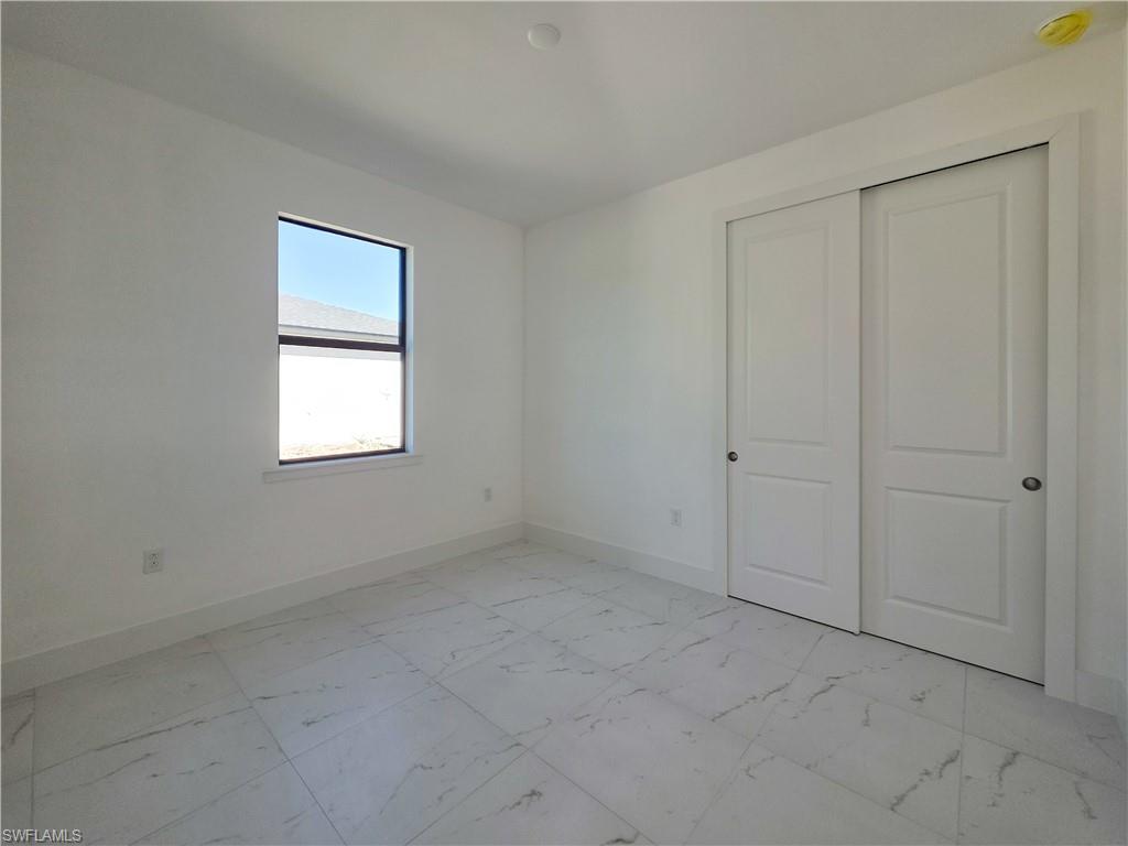 4814 30th Street Southwest Lehigh Acres, FL 33973 - Photo 10 of 11 an empty room with windows