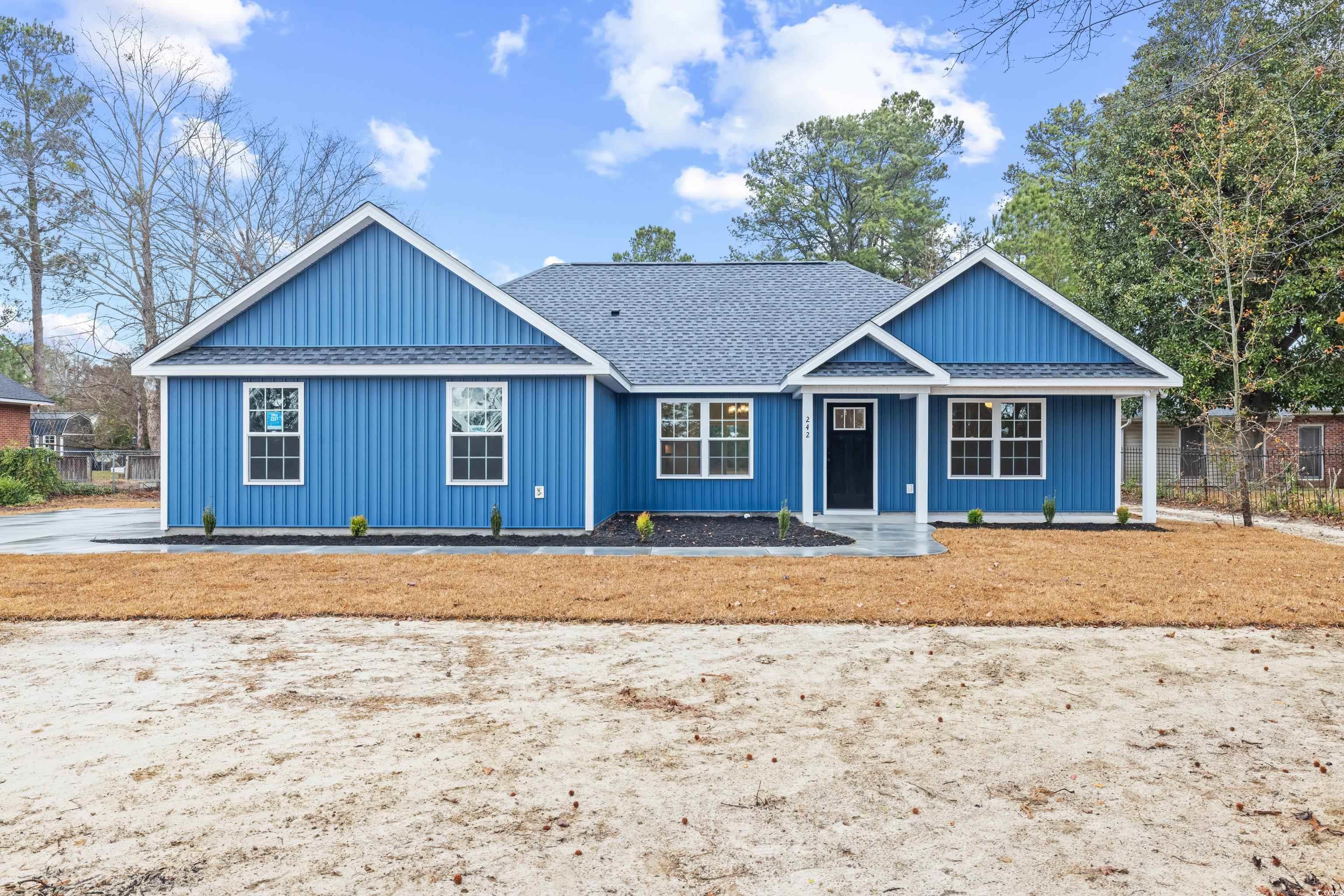 Single story home featuring roof with shingles and a porch