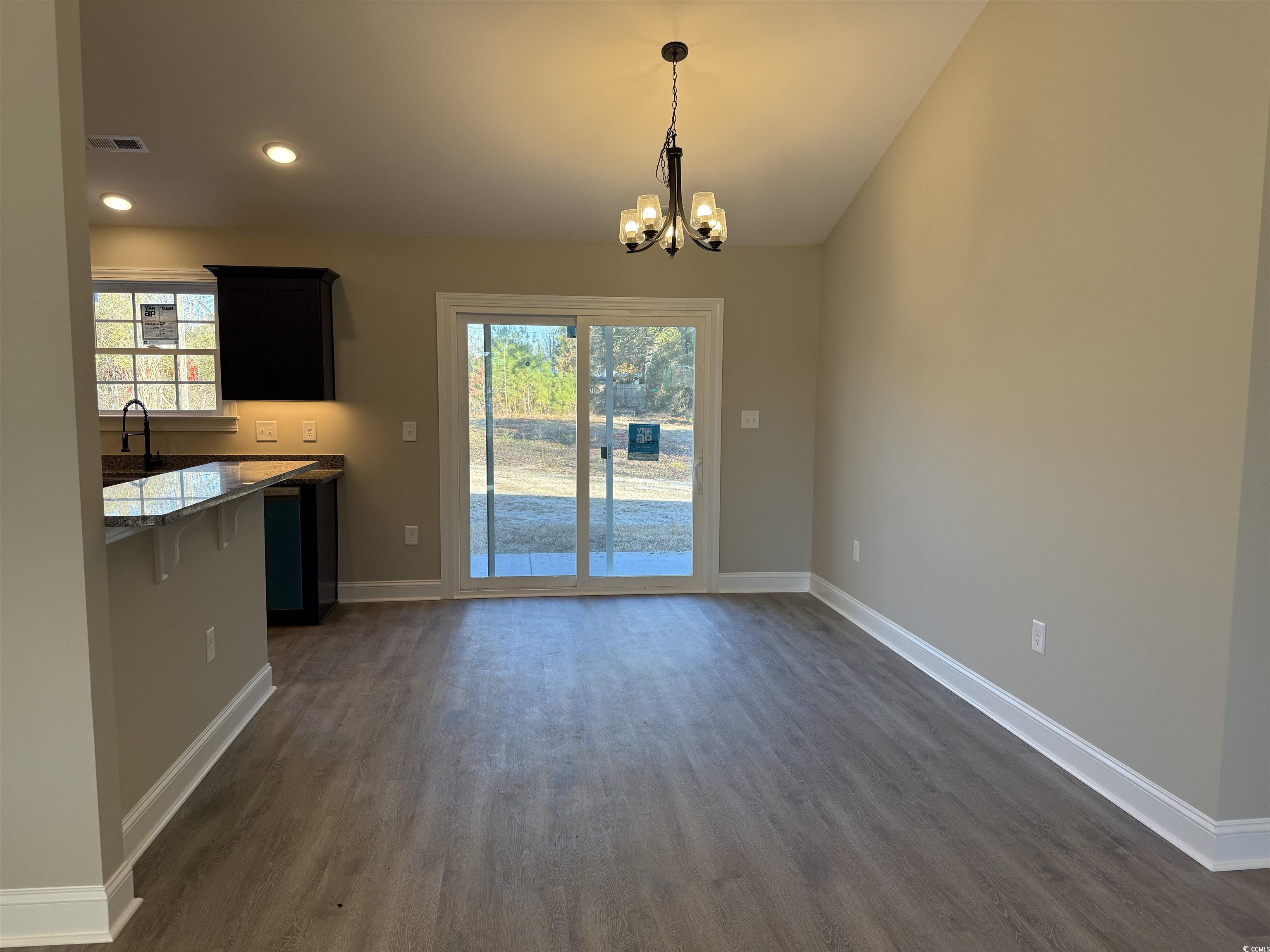 242 Country Club Road Marion, SC 29571 - Photo 12 of 33 Unfurnished dining area with dark wood finished floors, a chandelier, recessed lighting, and lofted ceiling