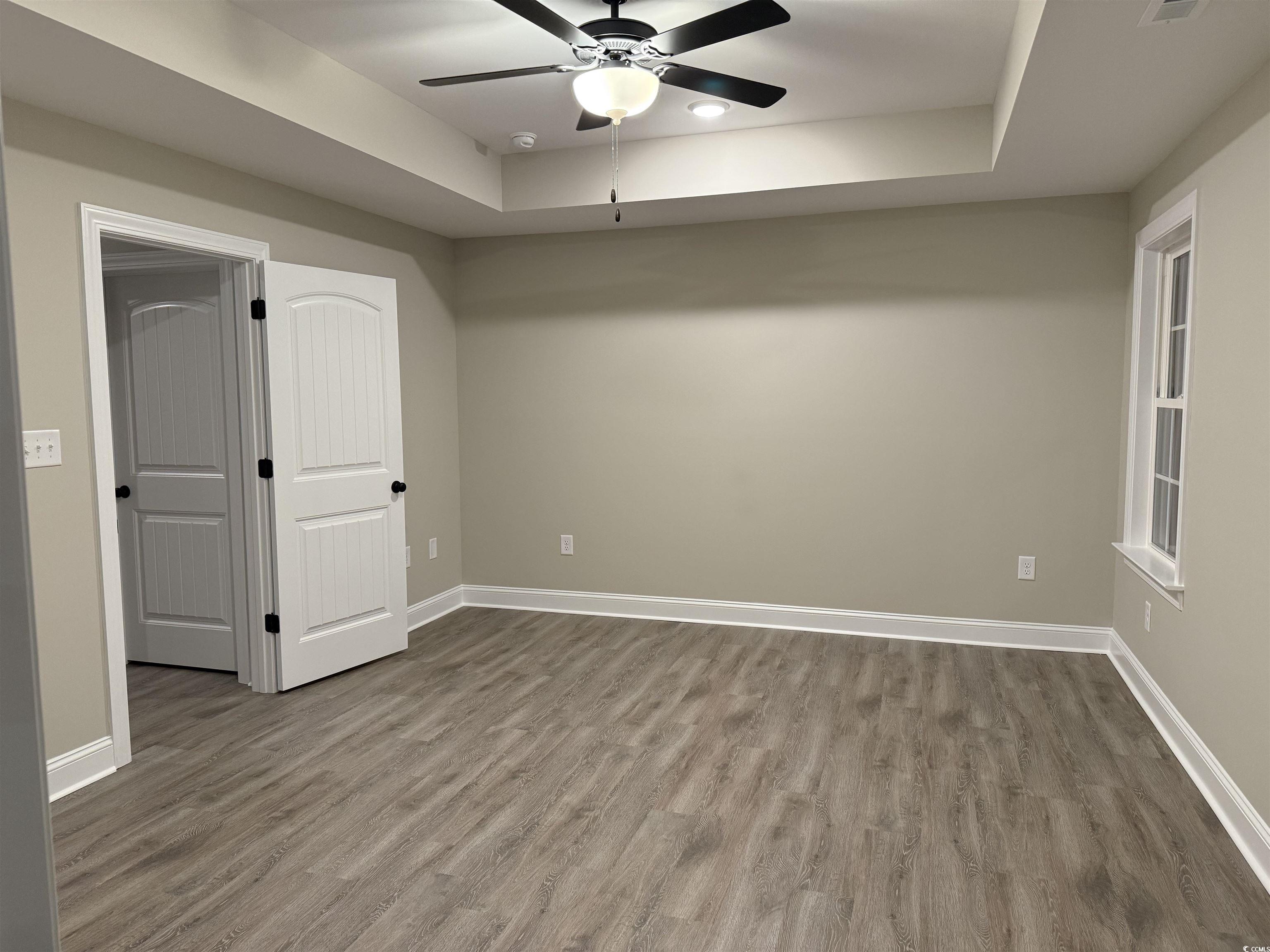 242 Country Club Road Marion, SC 29571 - Photo 20 of 33 Spare room featuring a raised ceiling, wood finished floors, and ceiling fan