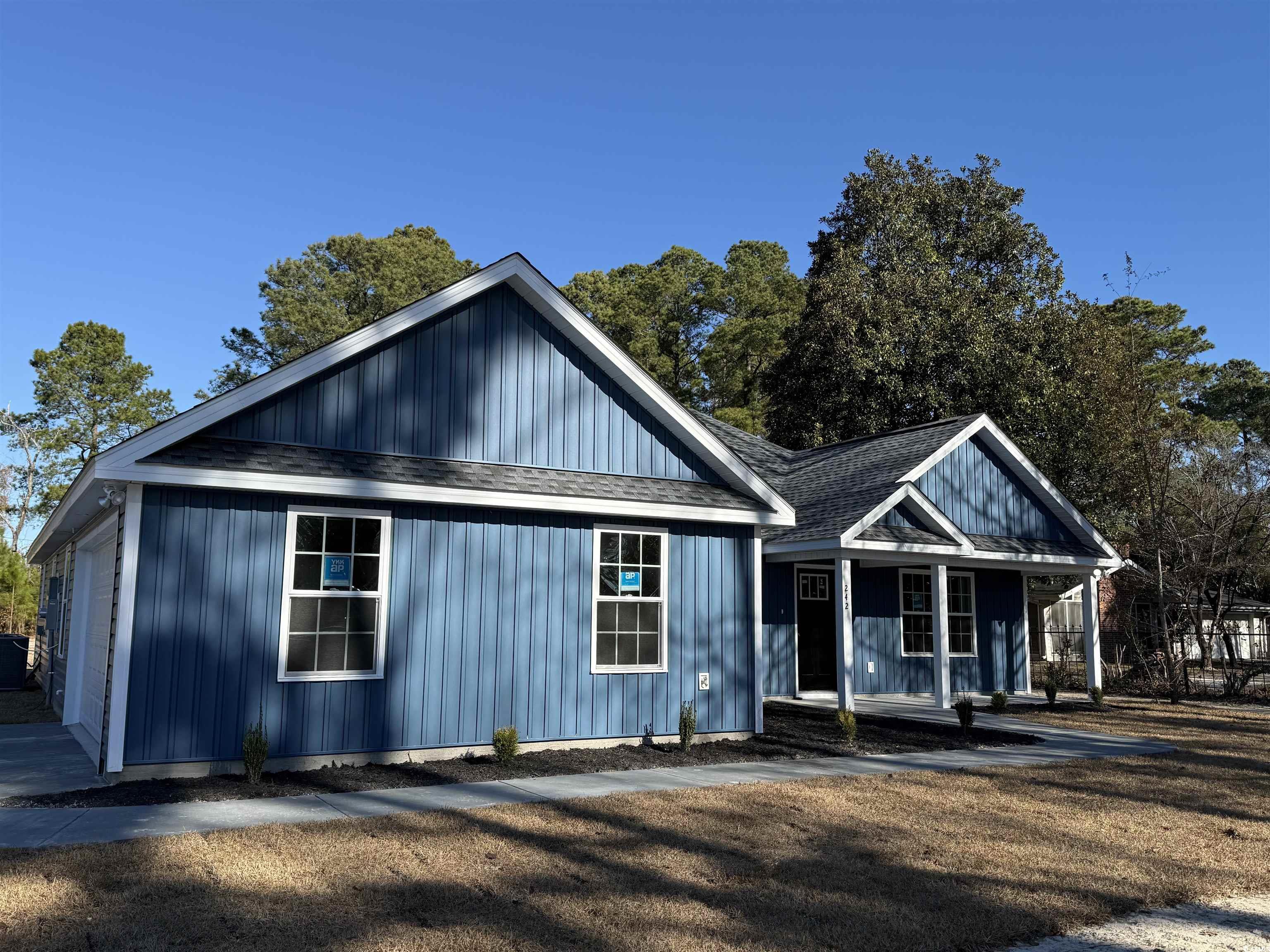 242 Country Club Road Marion, SC 29571 - Photo 2 of 33 View of front of home featuring covered porch and a shingled roof