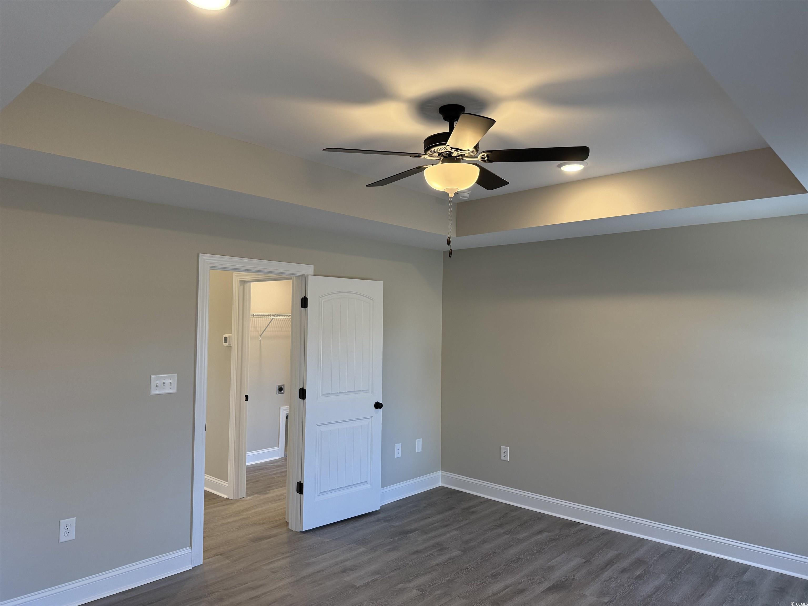 242 Country Club Road Marion, SC 29571 - Photo 21 of 33 Spare room with a raised ceiling, dark wood-style flooring, and ceiling fan