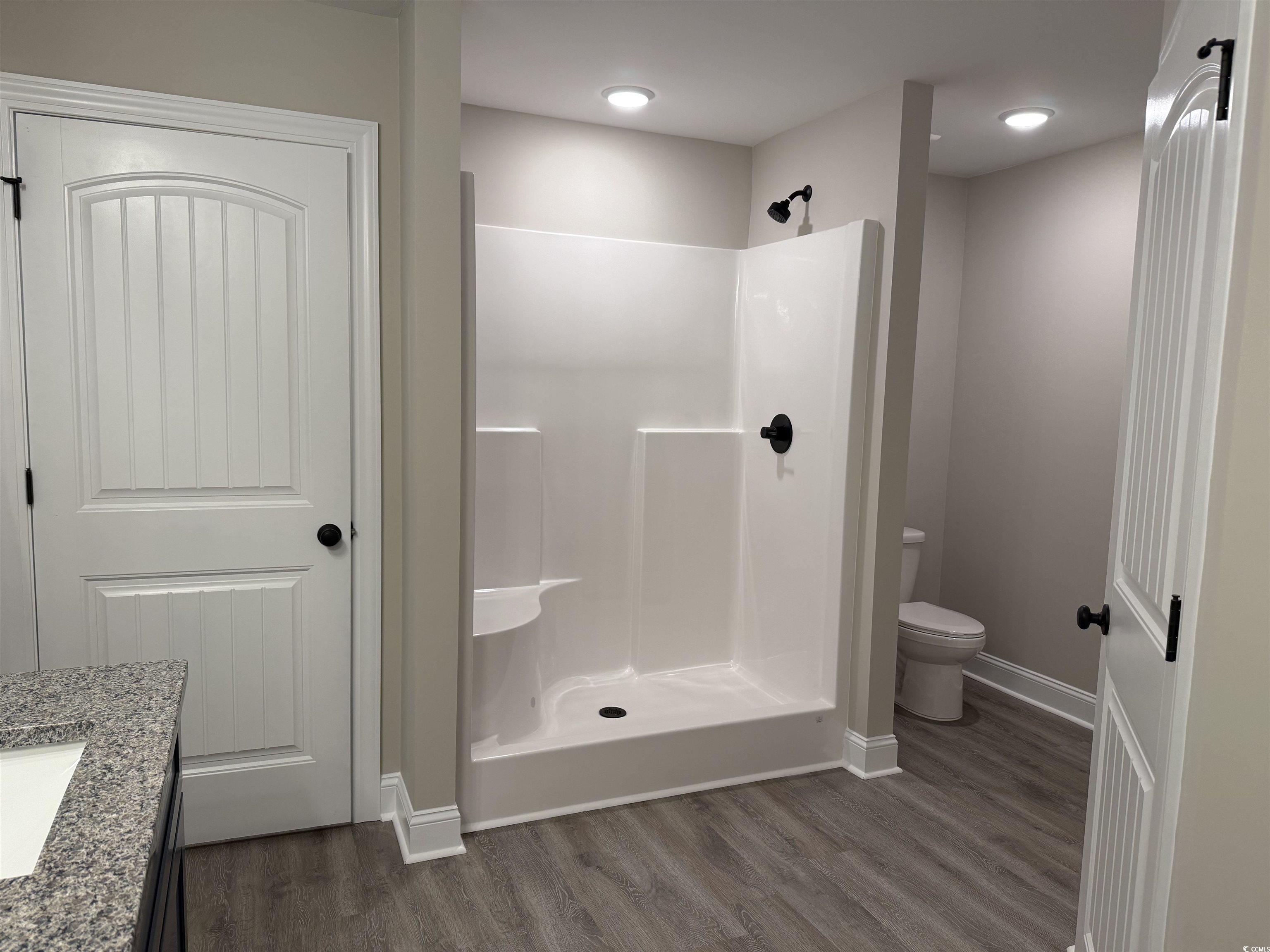 242 Country Club Road Marion, SC 29571 - Photo 24 of 33 Full bath featuring vanity, a shower stall, and dark wood-type flooring