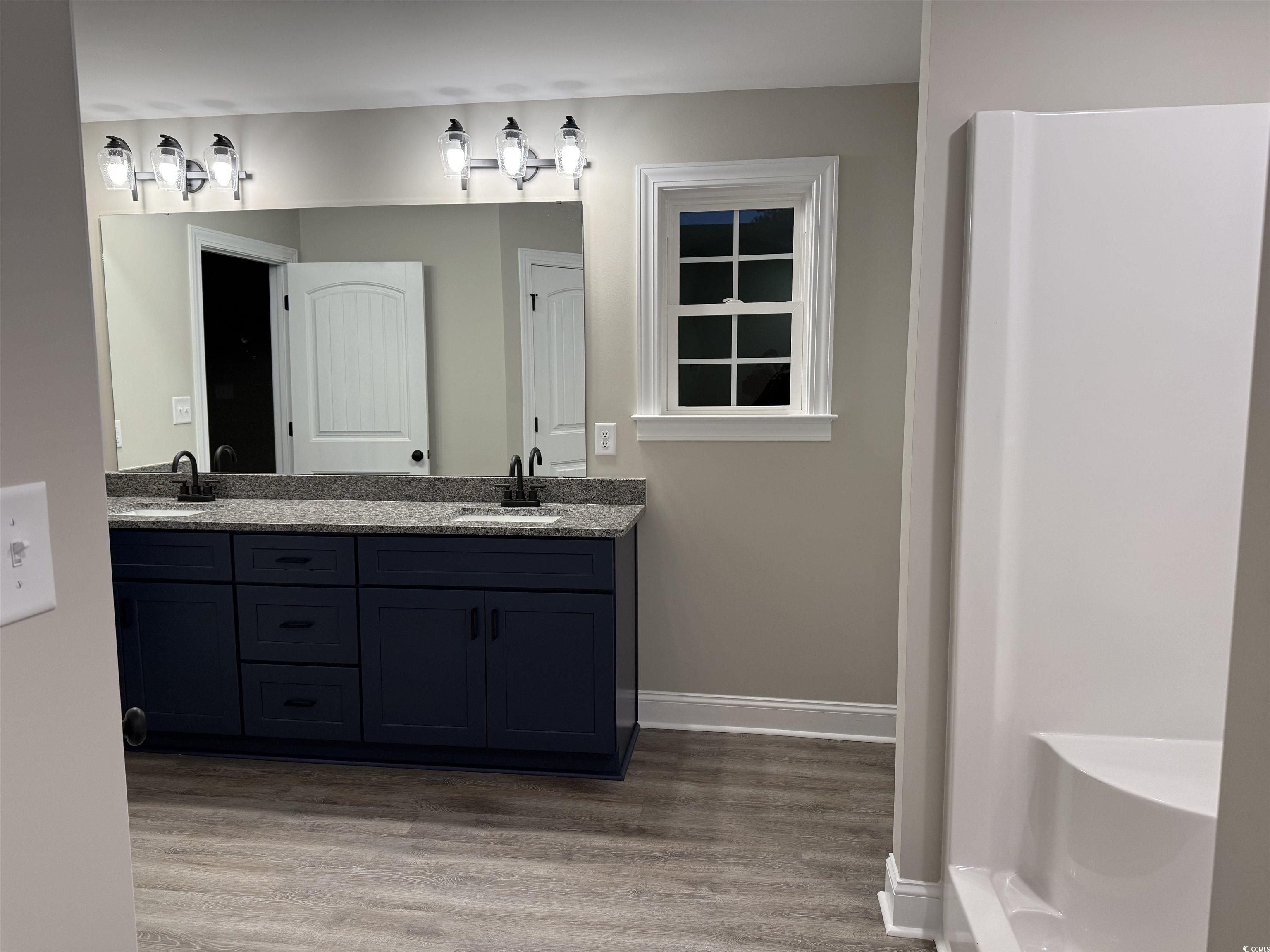 242 Country Club Road Marion, SC 29571 - Photo 25 of 33 Bathroom featuring double vanity and light wood-type flooring