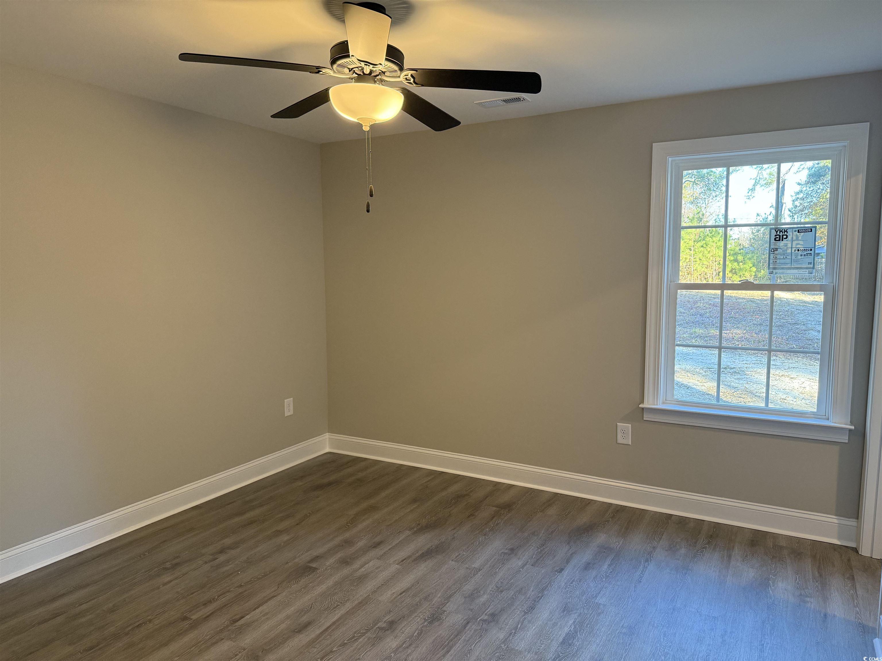 242 Country Club Road Marion, SC 29571 - Photo 28 of 33 Spare room featuring dark wood finished floors and a ceiling fan