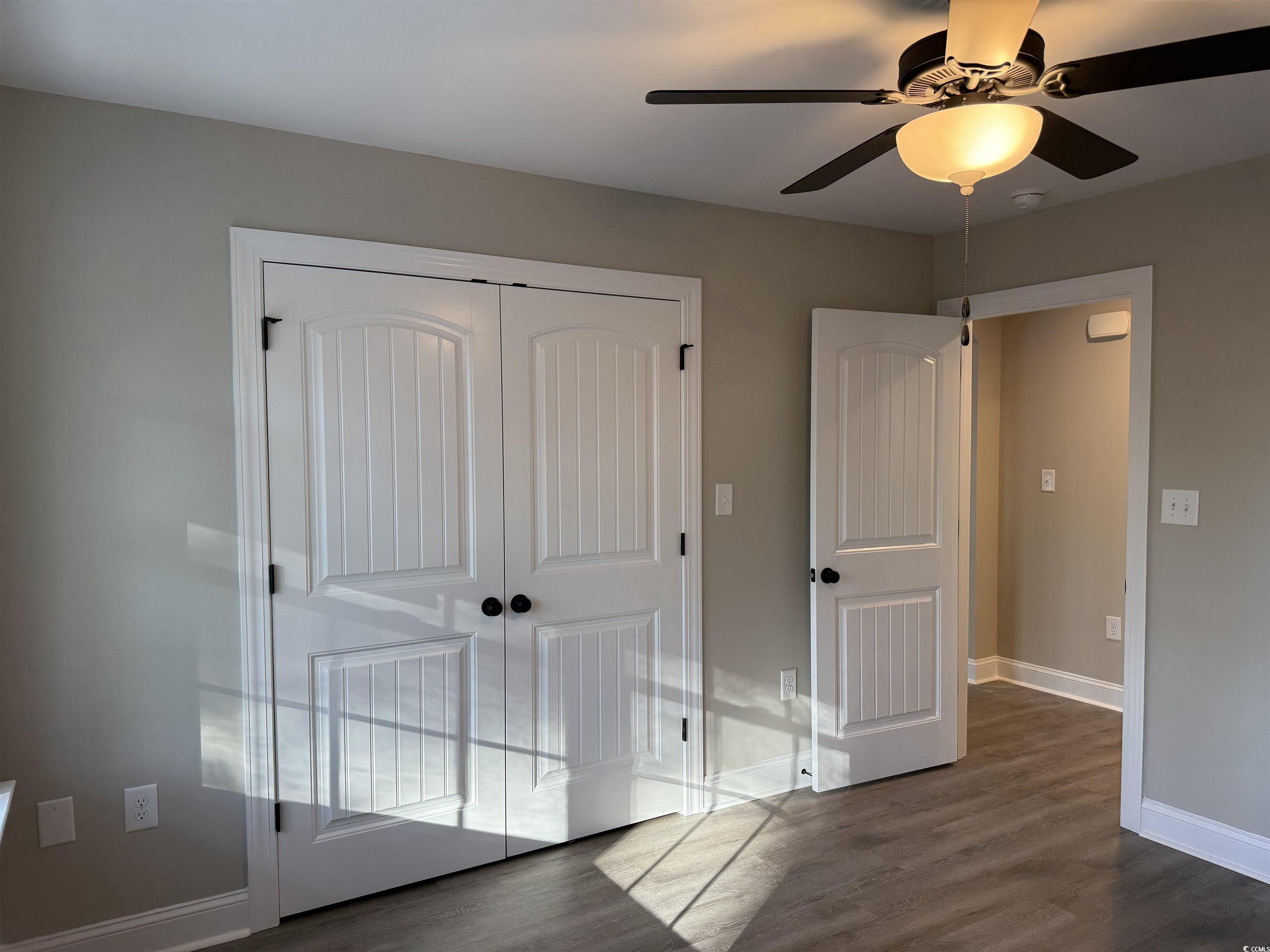 242 Country Club Road Marion, SC 29571 - Photo 32 of 33 Unfurnished bedroom featuring a closet, dark wood-style floors, and a ceiling fan