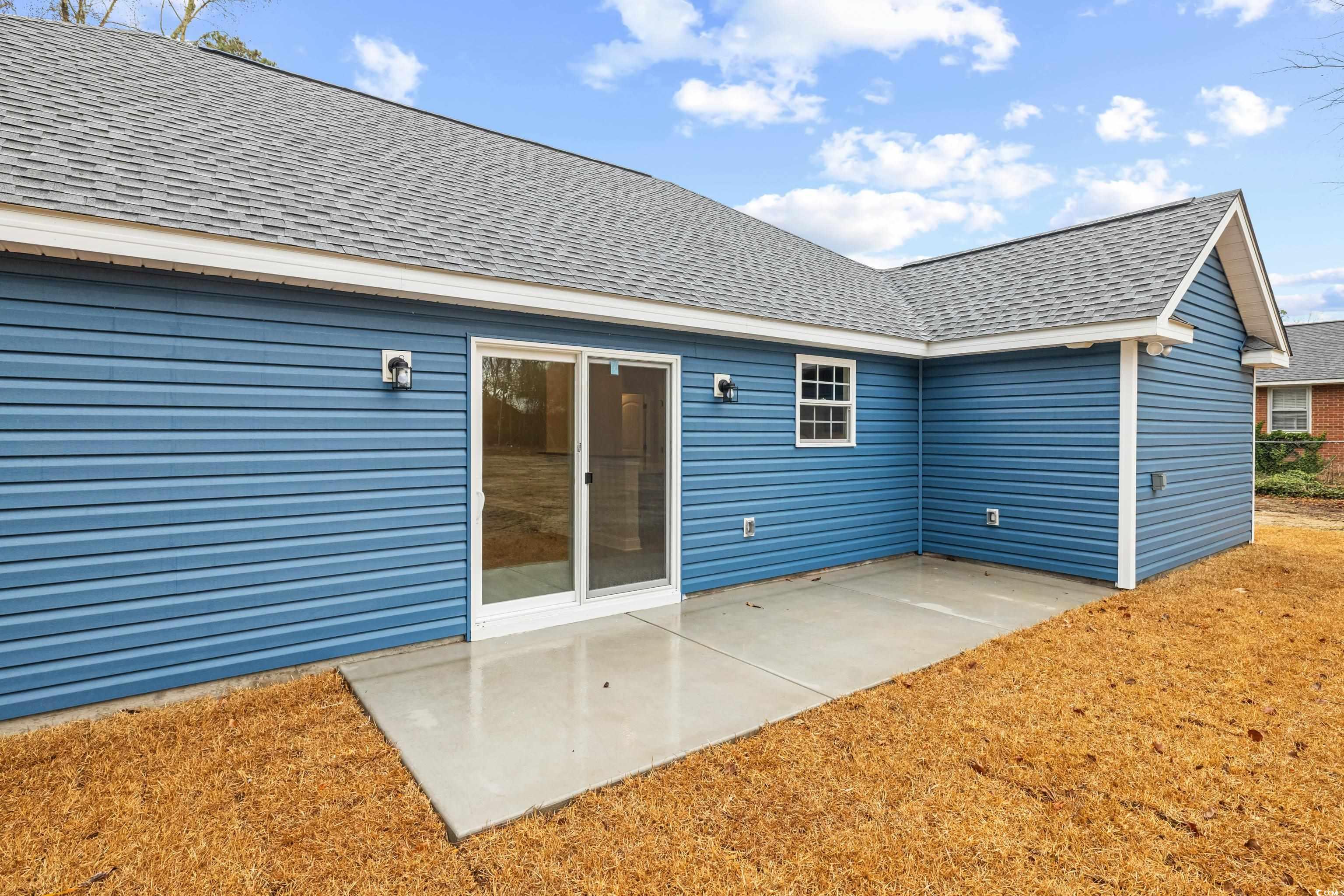 242 Country Club Road Marion, SC 29571 - Photo 6 of 40 Back of house featuring roof with shingles and a patio area