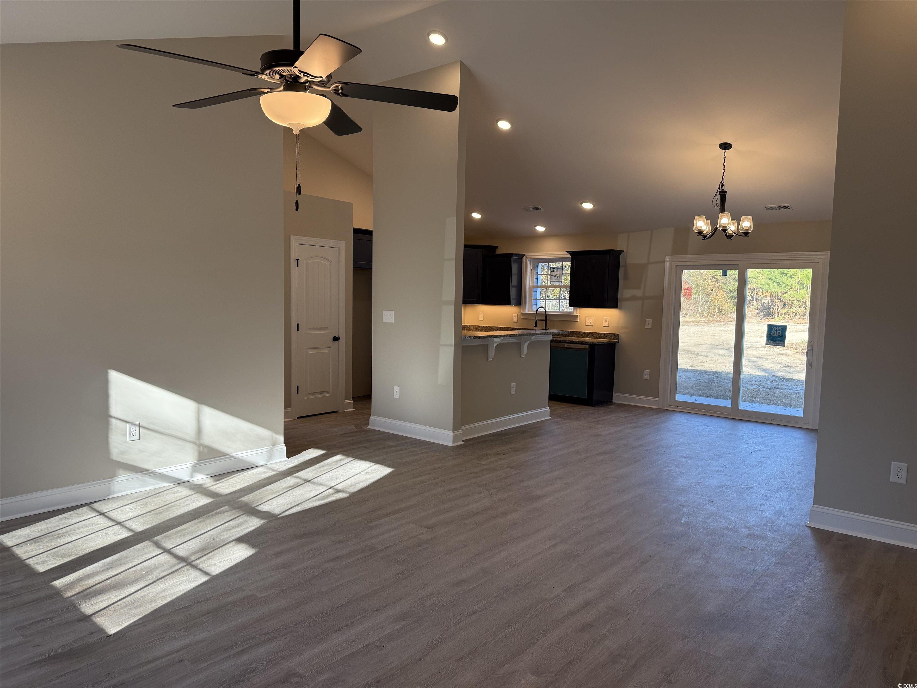 242 Country Club Road Marion, SC 29571 - Photo 7 of 33 Unfurnished living room featuring a chandelier, recessed lighting, dark wood-type flooring, high vaulted ceiling, and ceiling fan