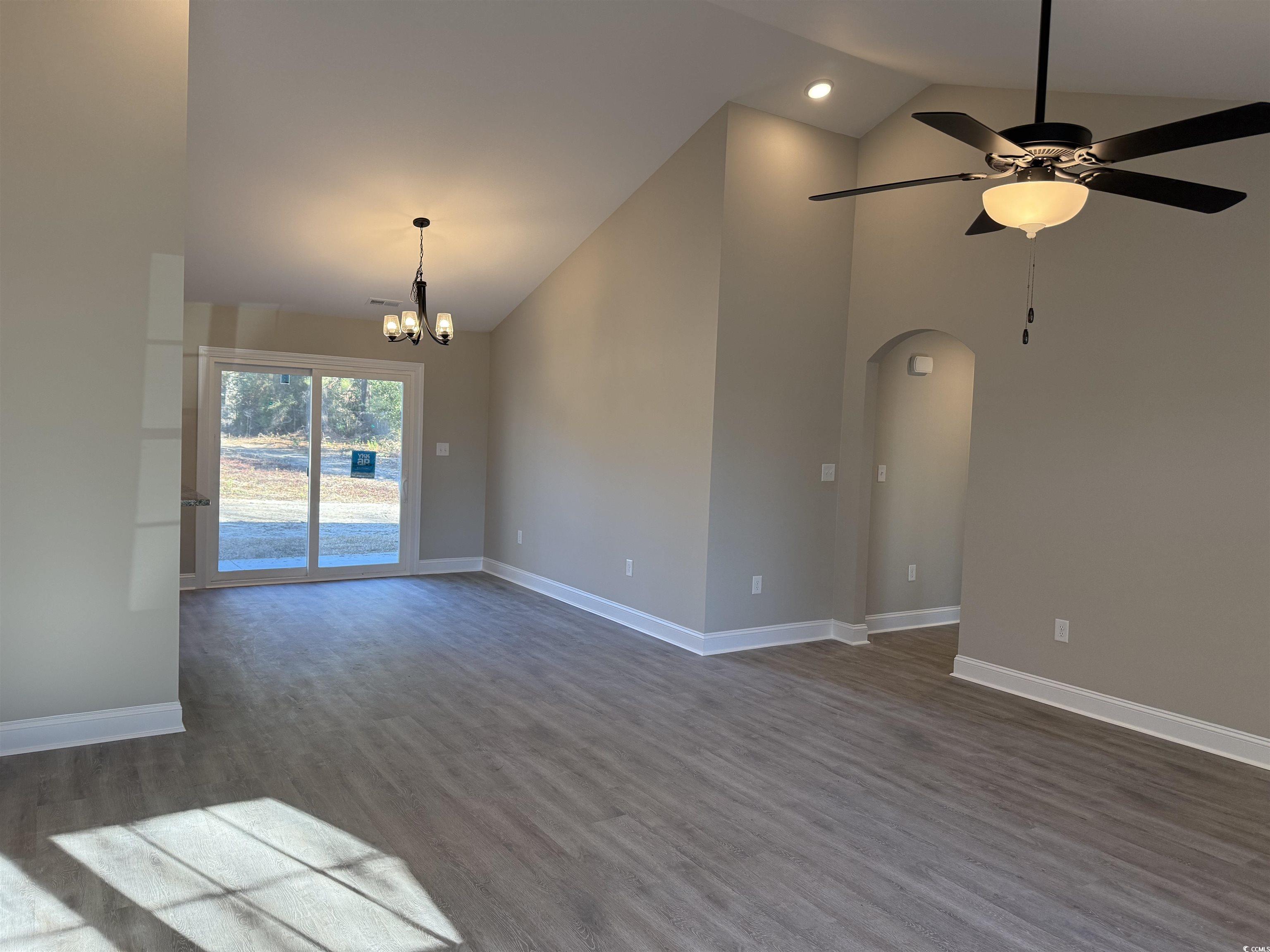 242 Country Club Road Marion, SC 29571 - Photo 9 of 33 Spare room with dark wood finished floors, high vaulted ceiling, a chandelier, a ceiling fan, and arched walkways