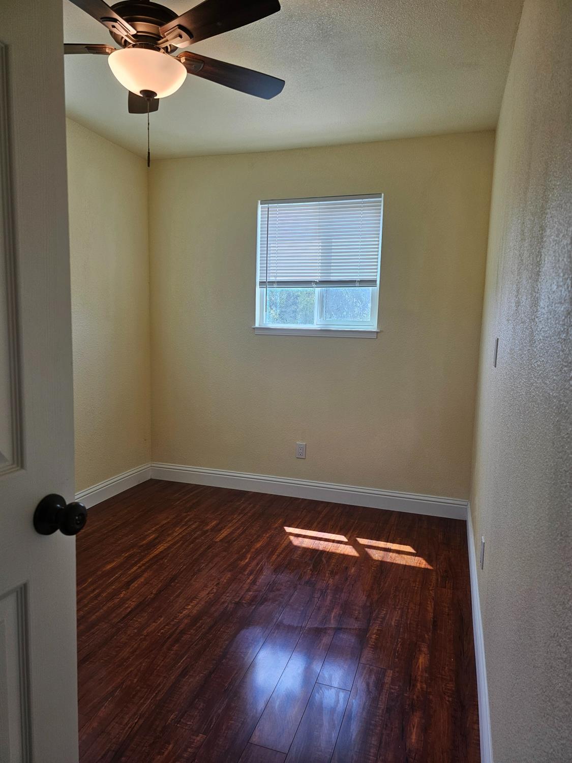 46 Arizona Way Olivehurst, CA 95961 - Photo 12 of 21 an empty room with a ceiling fan and wooden floor