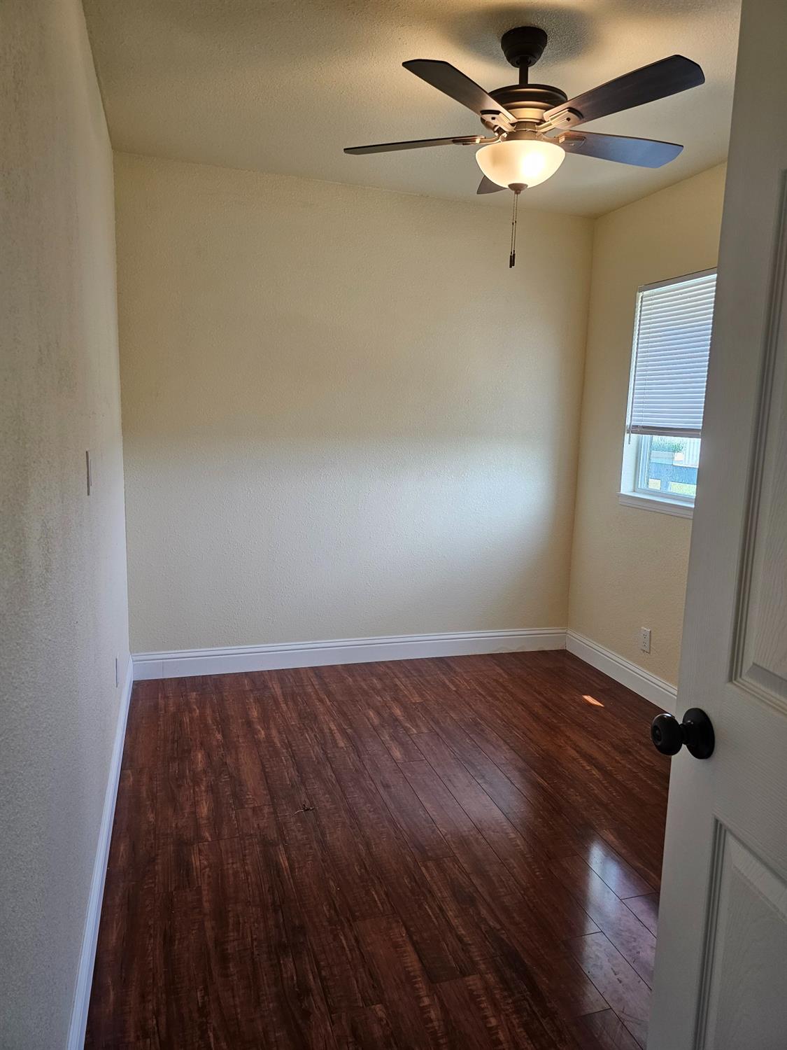 46 Arizona Way Olivehurst, CA 95961 - Photo 13 of 21 wooden floor in an empty room with a window
