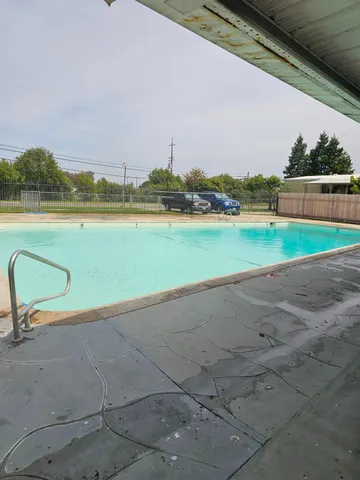 a kitchen with stainless steel appliances a stove a sink and a refrigerator