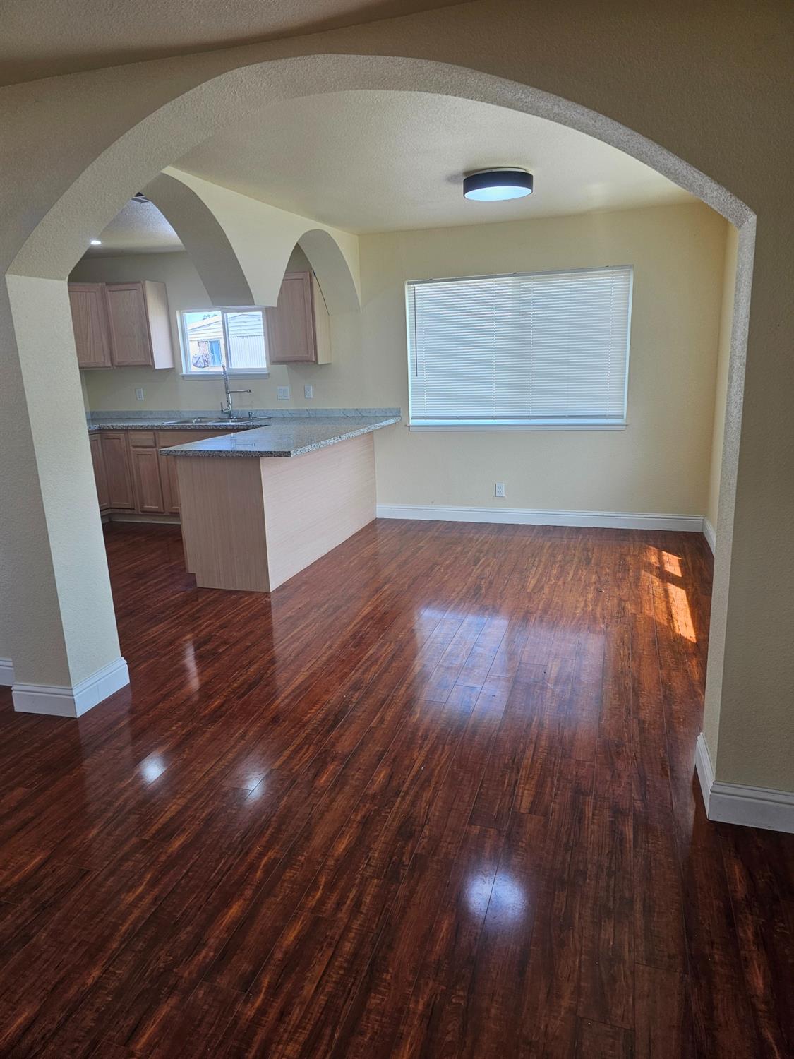 46 Arizona Way Olivehurst, CA 95961 - Photo 2 of 21 an empty room with wooden floor and cabinet