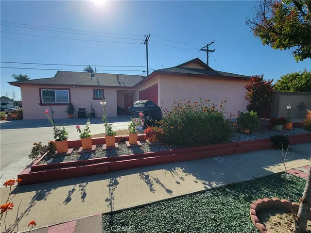 a view of a house with a yard and sitting area