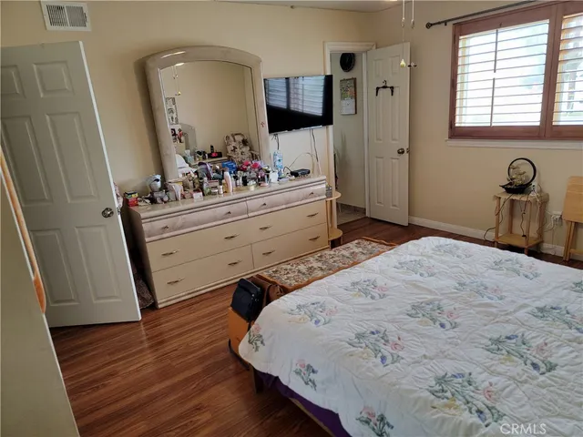 a bedroom with a bed and a dresser
