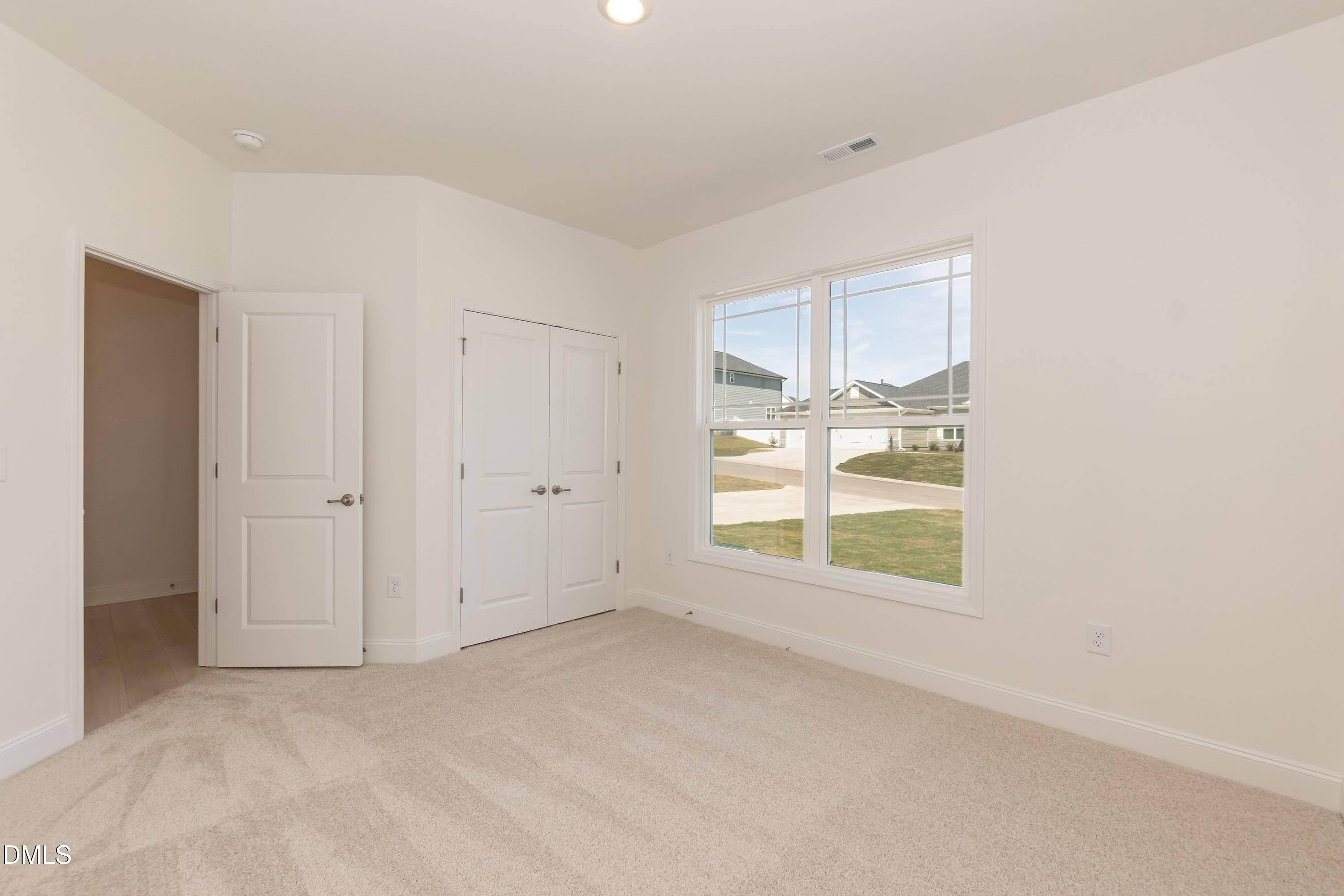 254 Galway Road Lillington, NC 27546 - Photo 6 of 35 an empty room with windows and closet