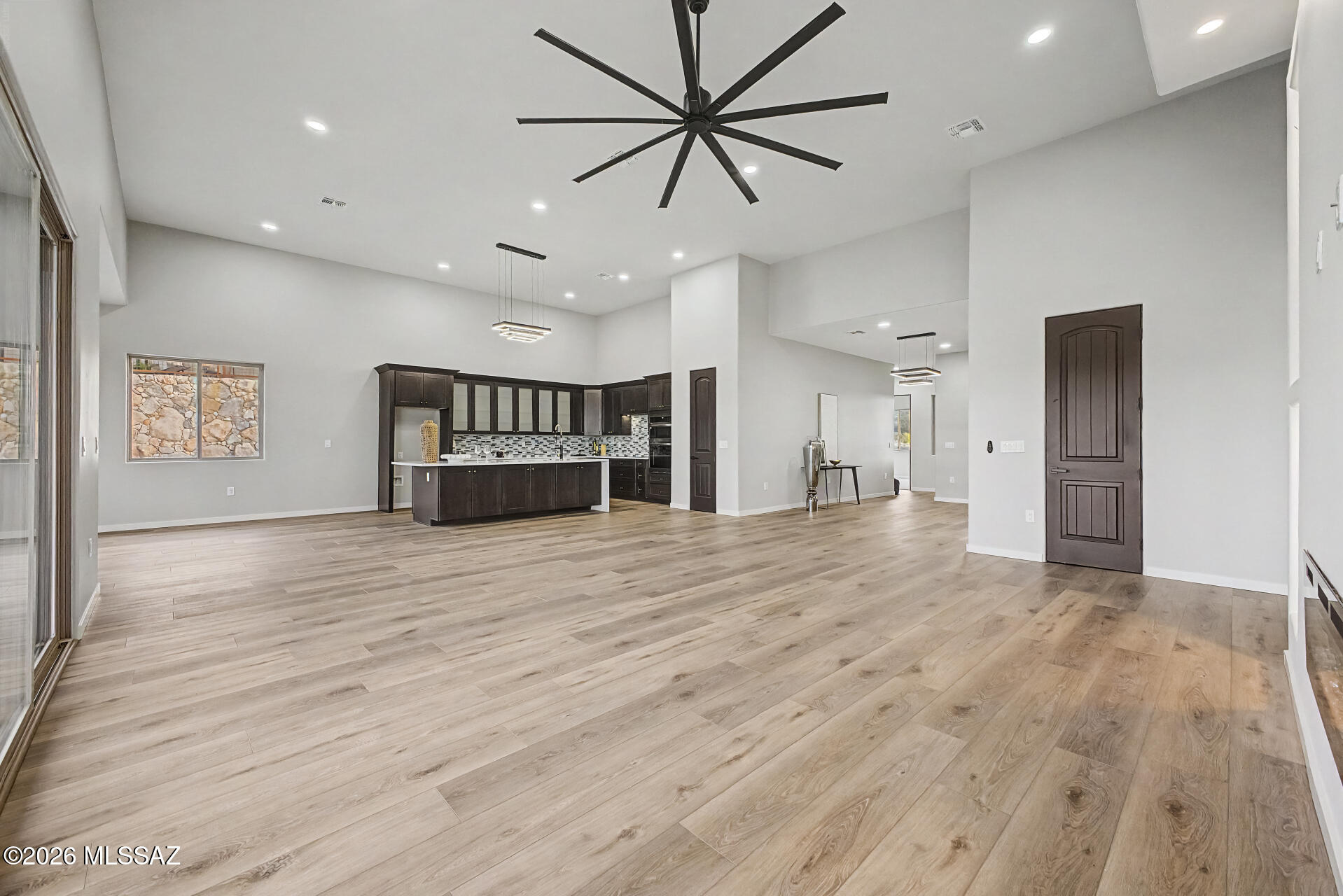 2399 Della Roccia Court Tucson, AZ 85737 - Photo 8 of 34 a big room with wooden floor and a ceiling fan