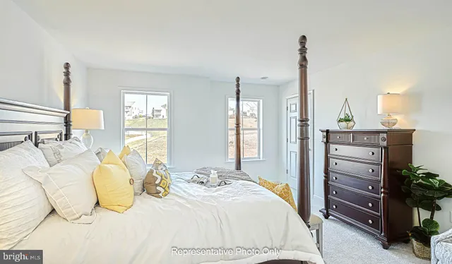 a bedroom with a bed and dresser with mirror