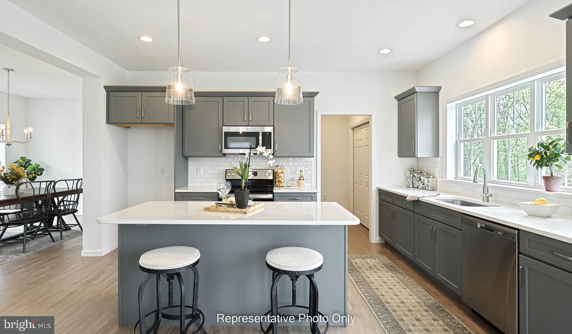 828 Kimmerlings Road Lebanon, PA 17046 - Photo 7 of 24 a kitchen with stainless steel appliances granite countertop a sink a stove a dining table and chairs
