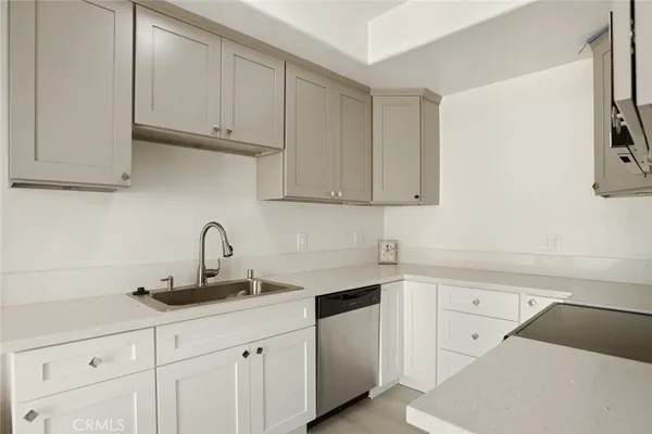 a kitchen with white cabinets and a sink