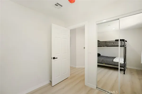 a bedroom with furniture and a chair